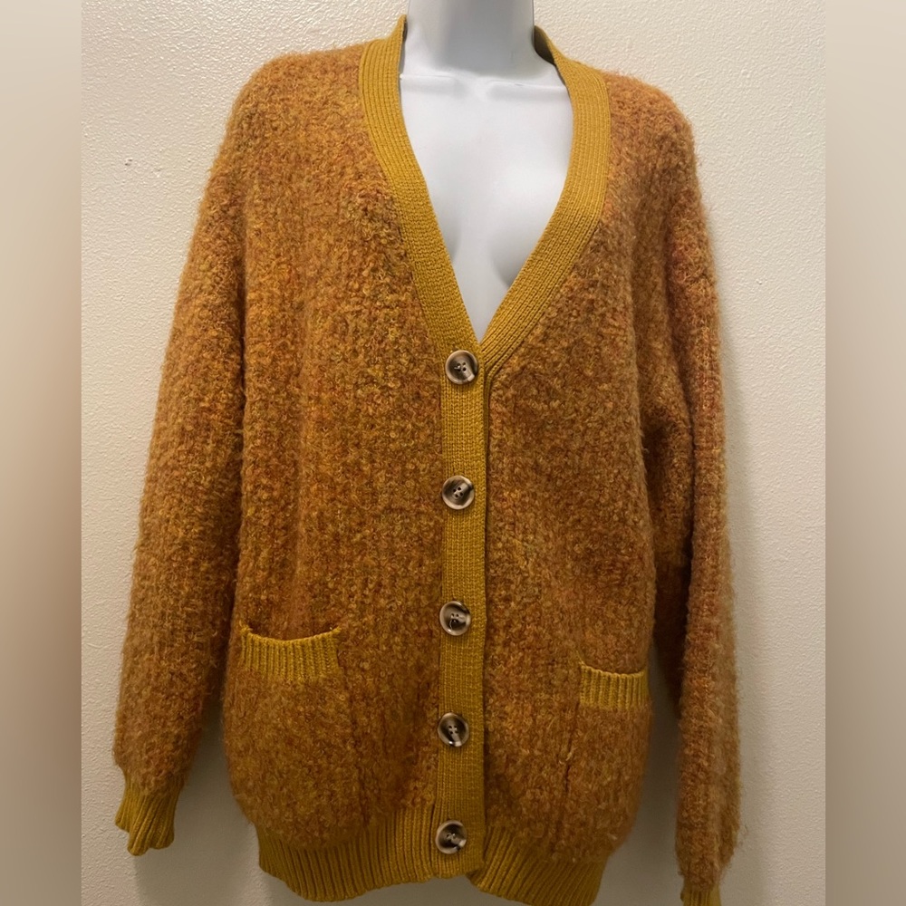 Mustard yellow cardigan.